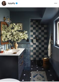 a bathroom with blue walls and checkered flooring is pictured in this instagramted photo