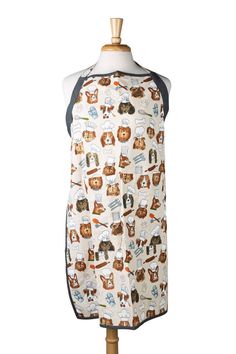 an apron on a mannequin with cats and dogs all over the front pocket