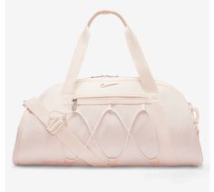 This spacious duffel bag from Nike is perfect for all your travel, casual, and work needs. The bag is made of 100% polyester exterior material and features a solid dusty pink pattern with silver, blush, light pink, baby pink, and rose character accents. It has a zip closure and comes with a detachable shoulder strap for added convenience. The bag is large in size, measuring 21 inches in width and 15 inches in height, and has a brown polyester lining. It also includes a pouch, coin purse, key holder, and detachable strap as accessories. The Nike One Club Women's Training Duffel Bag is a must-have for any sports enthusiast and is available for purchase now. Cheer Basketball, Nike Dance, Sport Bags Women, Volleyball Bag, Basketball Bag, Tennis Bag, Nike Pro Leggings, Training Bags, Dance Bag