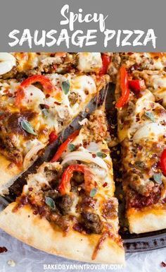 a pizza with cheese, sausage and peppers on it is cut in half to be eaten