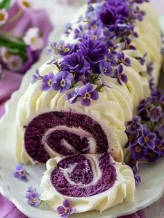 there is a cake with purple flowers on it