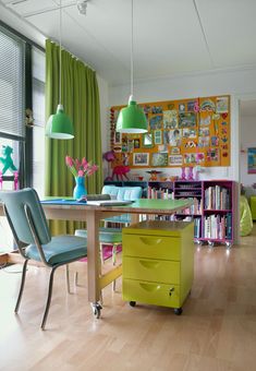 a brightly colored dining room with green curtains