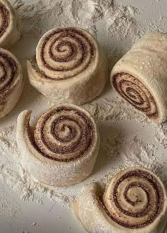 several cinnamon rolls sitting on top of a white counter