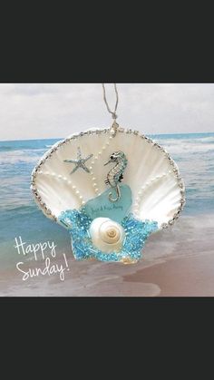 an ornament hanging from the side of a seashell with a starfish on it