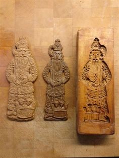 three carved wooden plaques sitting on top of a table