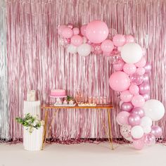 a pink and white party with balloons