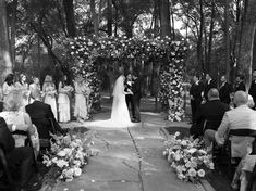 the bride and groom are getting married at their outdoor wedding ceremony in black and white