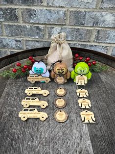 wooden toy cars and teddy bears on a table next to a bag with christmas decorations