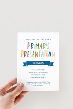 a person holding up a card with the words primary and secondary written in multicolored letters