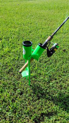 a fishing rod and reel holder in the grass