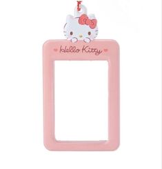 a pink hello kitty photo frame hanging from a string on a white background with the word hello kitty