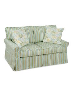 a green striped couch with two pillows on the arm and one pillow on the back