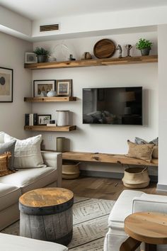 a living room filled with furniture and a flat screen tv mounted on a wall above a fire place