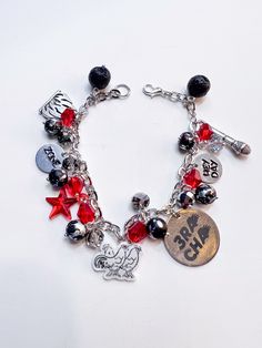 We all have a favorite SKZ unit, so why not show it off with one of our SKZ unit bracelets!  The 3Racha bracelet colors are red, black, and silver. The charms include a fire, the 3Racha bird, a microphone, a red star, a small circle that says Heyday, and one that says Zone.  The DanceRacha bracelet colors are blue and purple. The charms include a purple moon, a sneaker, an iridescent rose, a music note, and a small circle that says Wow and one that says Taste.  The VocalRacha bracelet colors are Skz Bracelet, Bracelet Colors, Purple Moon, Small Circle, Embroidered Tee, Pick And Mix, Music Note, Red Star, Charm Bracelets