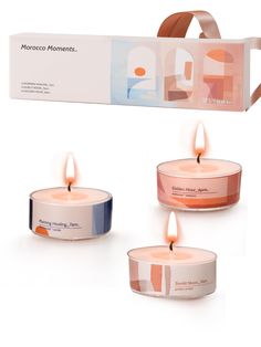 three candles are sitting next to each other in front of a box that says moroccan moments