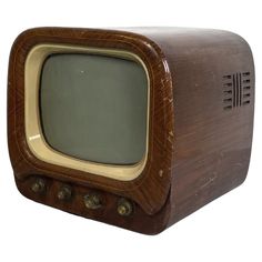 an old fashioned wooden tv sitting on top of a white background with the screen turned off