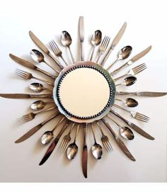 a mirror made out of forks and spoons