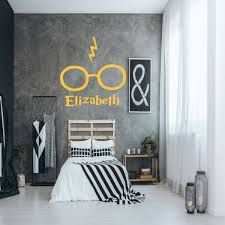 a bedroom decorated in black and white with harry potter wall decals