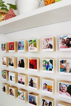 a wall with many pictures hanging on it