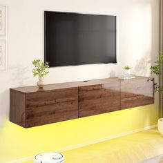 a flat screen tv mounted to the side of a wooden cabinet in a living room