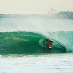 a person on a surfboard riding a wave