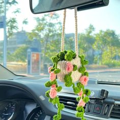 the interior of a car with flowers hanging from it's dash board