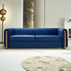 a blue couch sitting in the middle of a living room