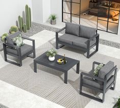 an outdoor living room with grey furniture and cactus