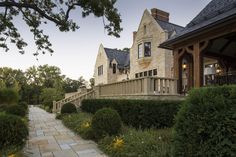 a stone walkway leading to a large house