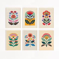 four flower prints are arranged in squares on a white surface, each with different colors