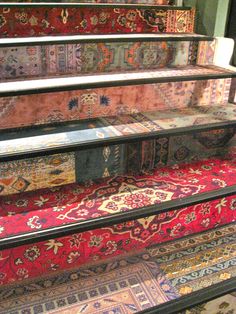 a bunch of rugs that are on some stairs