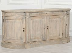 a large wooden cabinet sitting on top of a hard wood floor next to a white wall