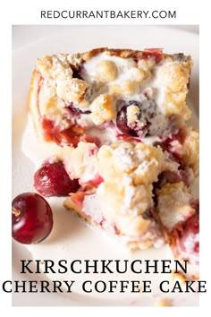 a close up of a piece of cake on a plate with cherries next to it