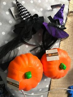 two fake pumpkins are sitting next to each other on a polka dot tablecloth