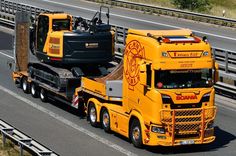 a yellow semi truck hauling a tractor trailer