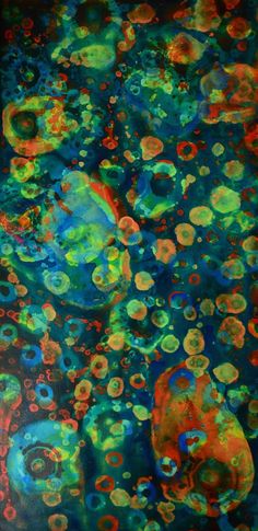 an abstract painting with lots of different colors and shapes on it, including circles in the middle