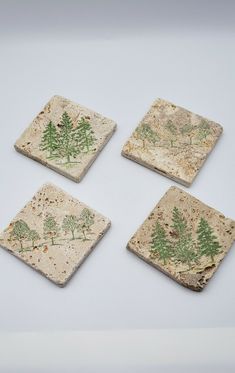 four pieces of stone with trees on them