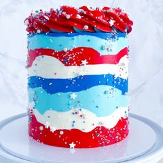 a red, white and blue cake with sprinkles