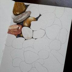 an image of some rocks and pebbles on a piece of paper with watercolor pencils