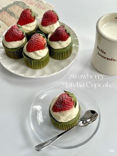 cupcakes with strawberries and cream on them are sitting next to a coffee mug