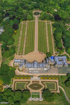 an aerial view of a large estate in the middle of a lush green area with lots of trees