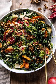 a white bowl filled with greens and nuts