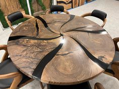 a wooden table with chairs around it in the middle of a floored room area