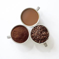 three mugs filled with different types of coffee