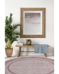 a room with a rug, potted plants and a framed painting on the wall