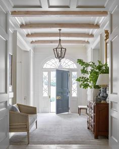 an entry way with a blue door and white walls