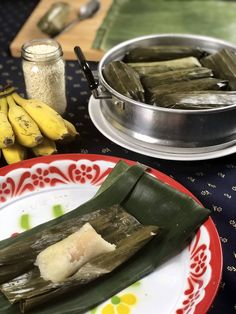 there is a plate with some food on it next to bananas and other foodstuffs