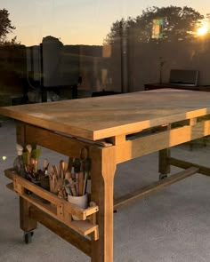 a wooden table sitting on top of a cement floor