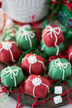 green and red chocolate covered strawberries with white sprinkles on the top