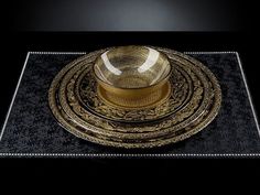 a black and gold place setting on a table